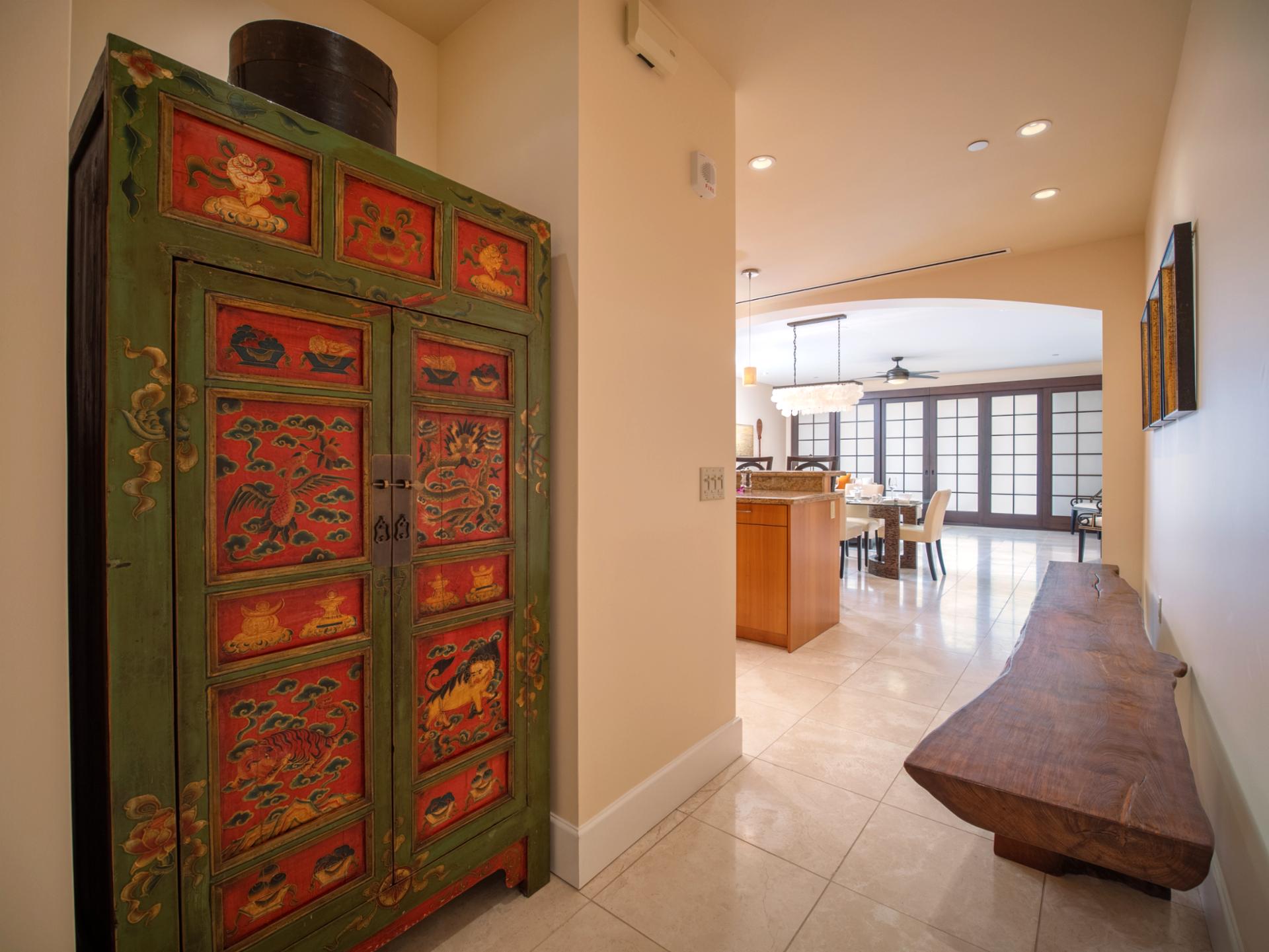 A carved red cabinet and curved wood bench bring personality and function to your entry hall.