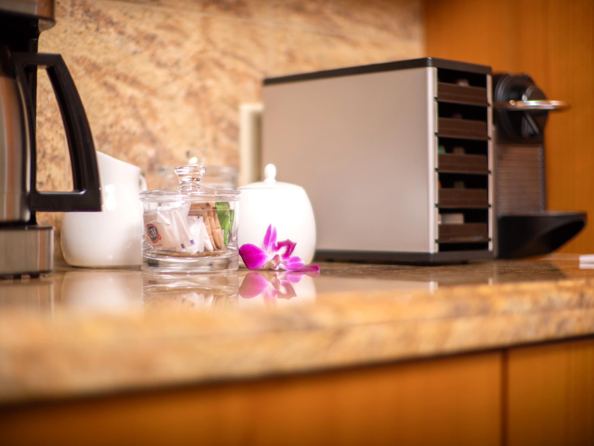 Morning essentials are ready, with a drip coffee maker and Nespresso on hand.