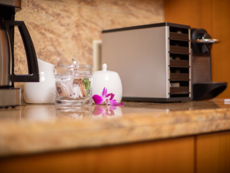 Morning essentials are ready, with a drip coffee maker and Nespresso on hand.