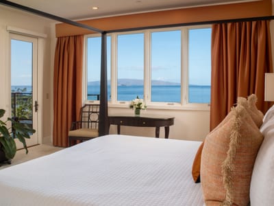 Breezy curtains and island furnishings create a calming retreat with wraparound windows.