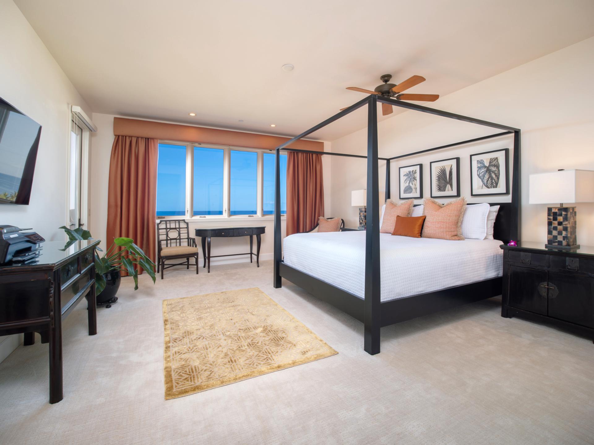 Wake up to ocean views from your spacious King bedroom with four-poster bed and private lanai access.
