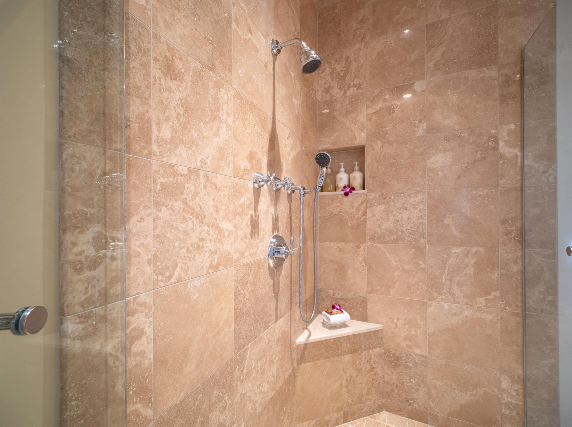 A walk-in shower with stone tile rounds out your luxury bath experience.
