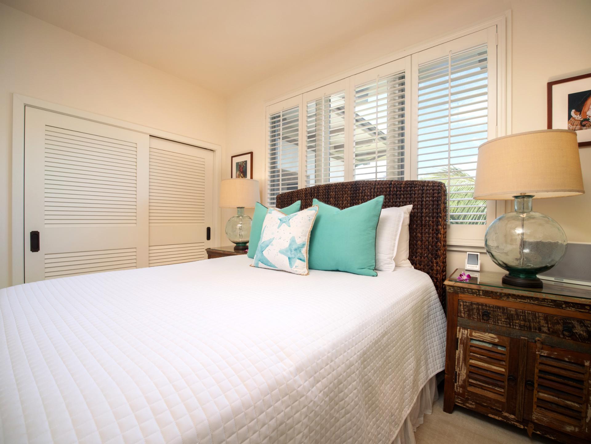Sleep soundly with plantation shutters, breezy white linens, and a tropical color palette.