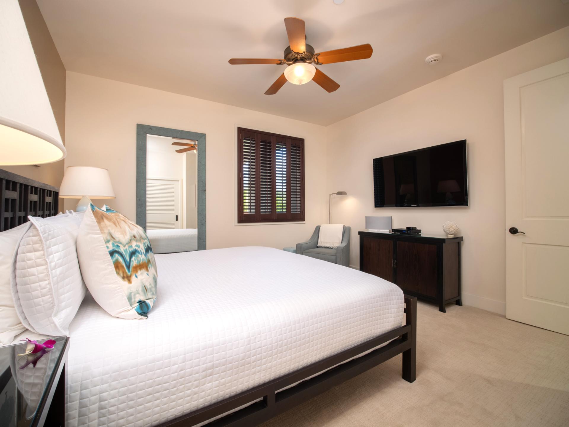 Plantation shutters and soft lighting make this King room cozy yet spacious.