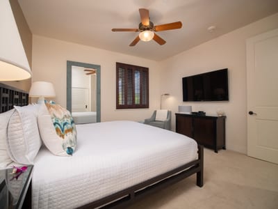Plantation shutters and soft lighting make this King room cozy yet spacious.