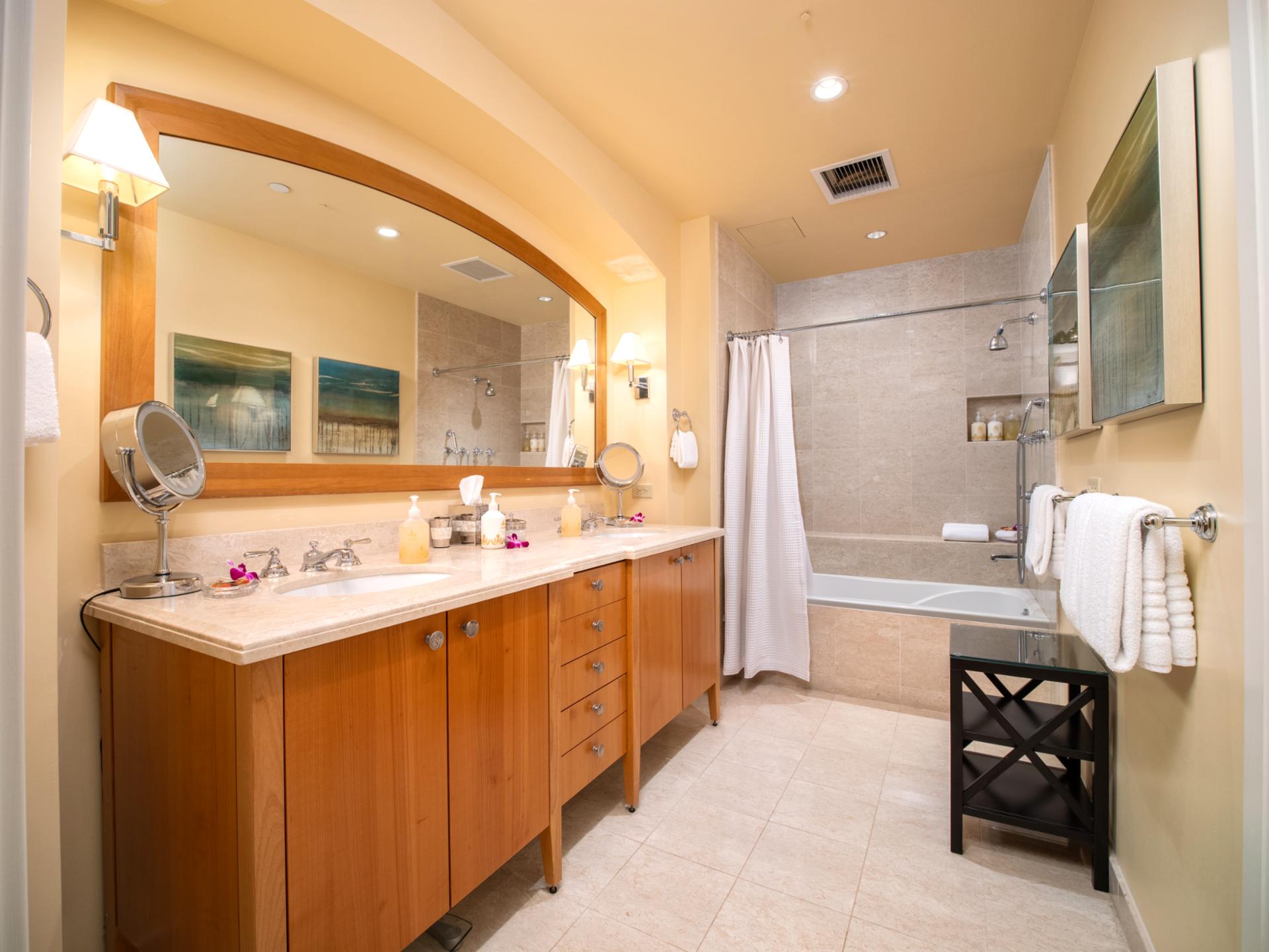 Dual-sink vanity and shower/tub combo offer a fully equipped space with L’Occitane amenities for a luxe refresh.