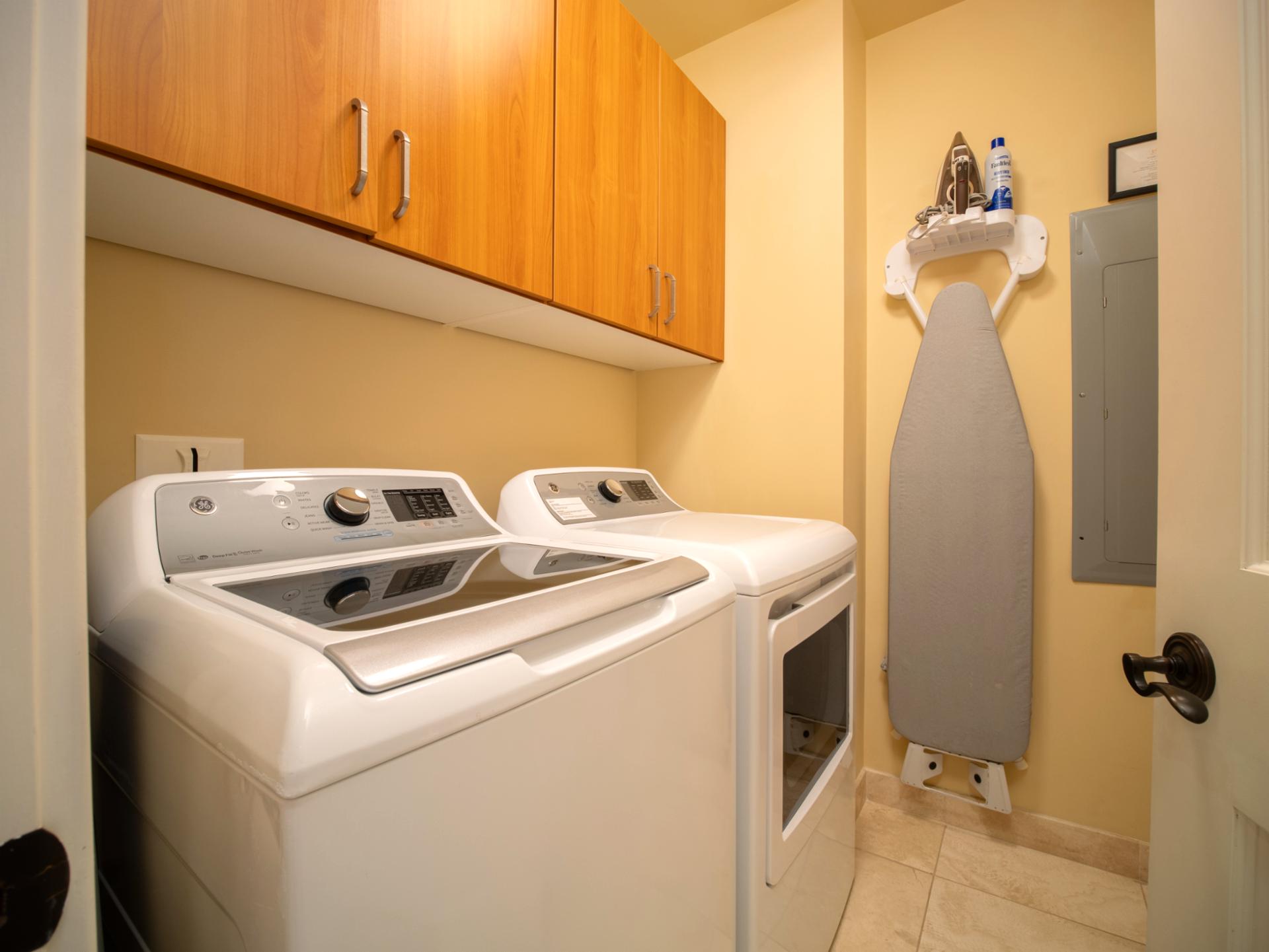 Full-size washer and dryer tucked into a separate laundry room for easy mid-stay refreshes.