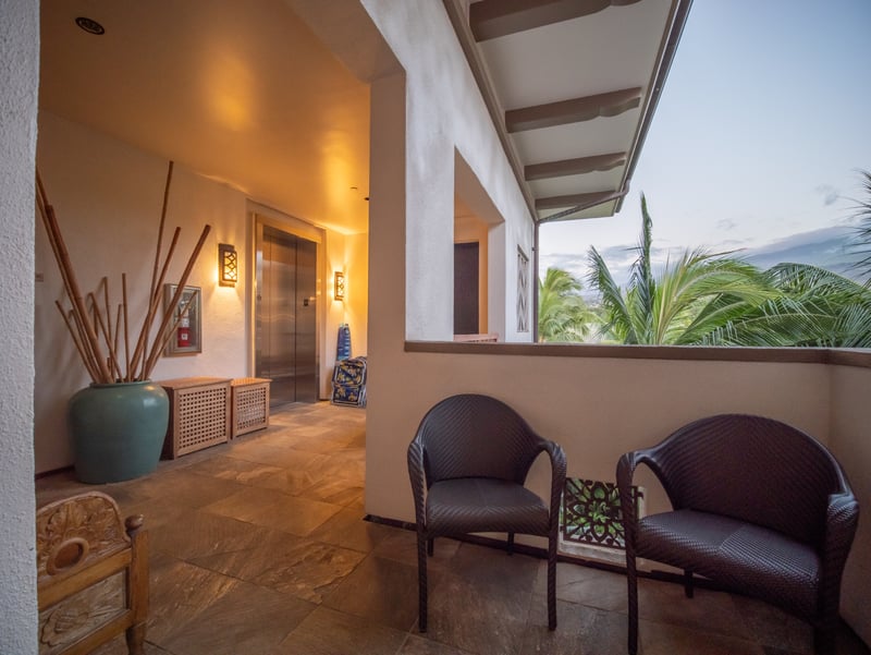 Covered entry patio with seating lets you pause and enjoy the view before heading out.
