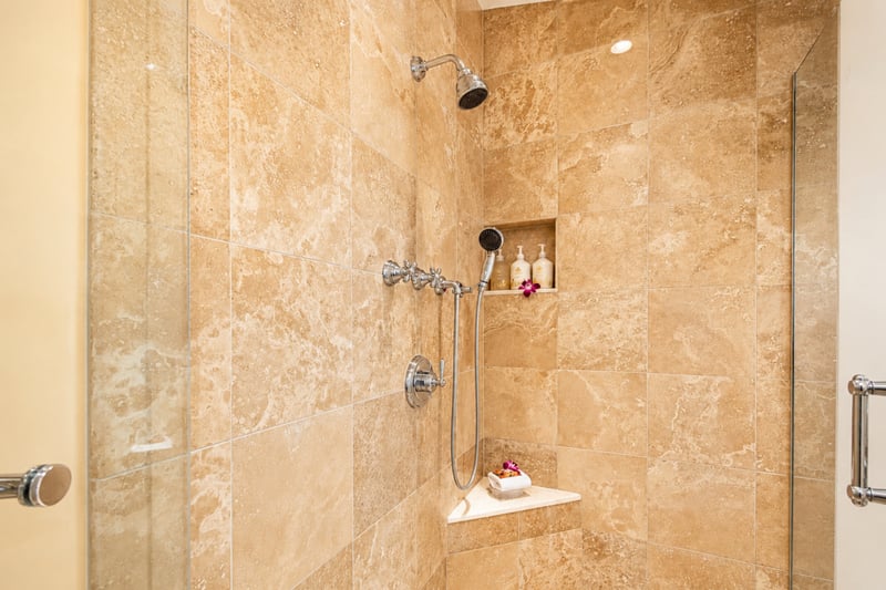 Primary bath shower at Wailea Beach Villas PH505 — glass-enclosed shower with a built-in corner bench and amenity niche WBV-PH505