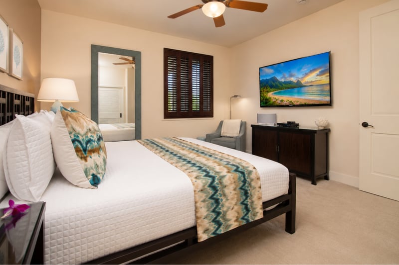 Guest bedroom at Wailea Beach Villas PH505 — coastal white and teal decor with a starfish accent pillow and smart TV WBV-PH505