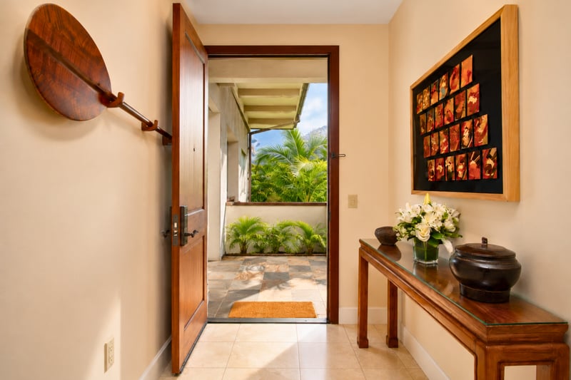 Front entry at Wailea Beach Villas PH505 — covered lanai walkway framed by tropical palms WBV-PH505