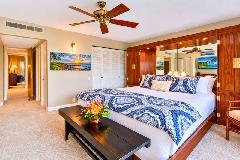 Comfortable primary bedroom featuring a plush king bed and island-inspired decor.