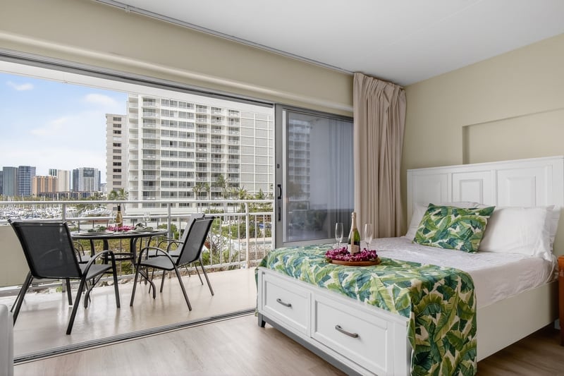 Spacious bedroom area featuring island-inspired décor and natural light. ILK-437