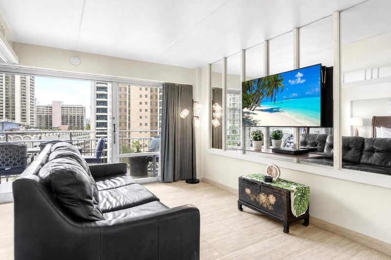 Bright island-inspired living area with comfortable seating, large smart TV, and easy access to the private lanai