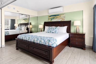 The comfortable bedroom area features a floor to ceiling length mirror, perfect for getting ready for a night out