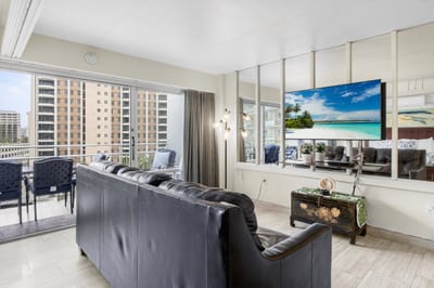Open-concept living room with contemporary furnishings, smart TV, and seamless indoor-outdoor island living