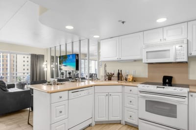 Fully equipped kitchen with modern appliances, ample counter space, and custom cabinetry.