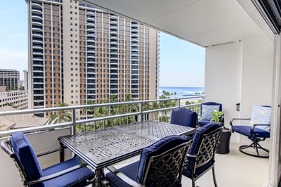 Expansive lanai offering outdoor dining space and views of the harbor.