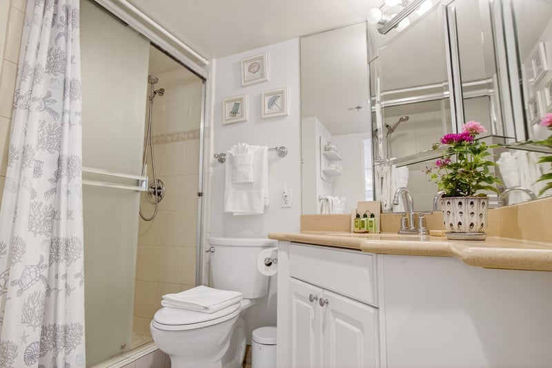 Clean and bright master bathroom featuring a large vanity and walk-in shower. ILK-732