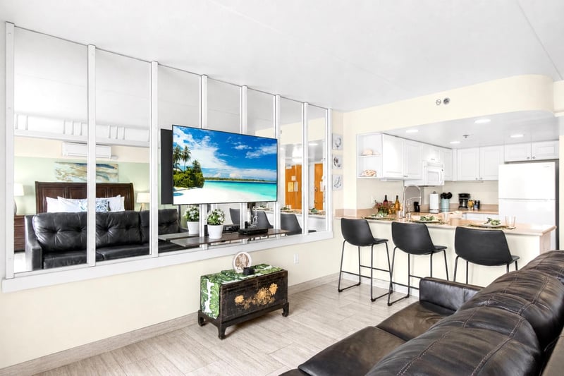 Elegant living area seamlessly connected to the dining space and lanai, perfect for relaxing after a day in Waikiki. ILK-732