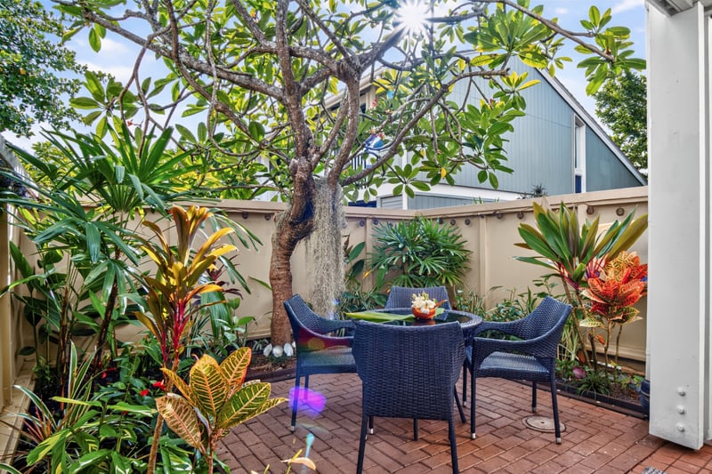 Relax on the private lanai surrounded by lush tropical landscaping