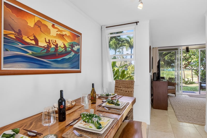 Enjoy meals together in the inviting dining area with tropical artwork