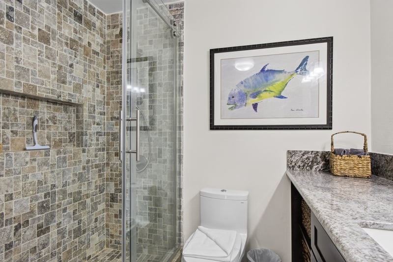 Spacious bathroom with a walk in shower and granite countertops