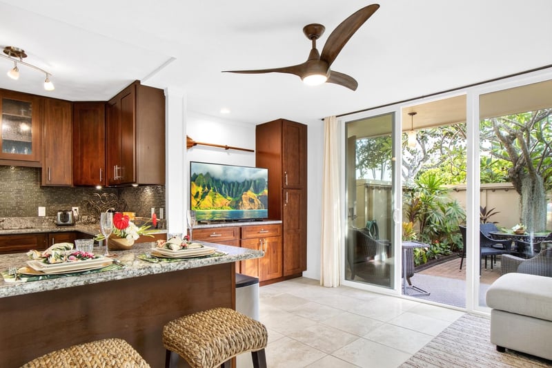 Well equipped kitchen with granite countertops and bar seating