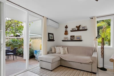 Bright island inspired living room with comfortable seating and natural light