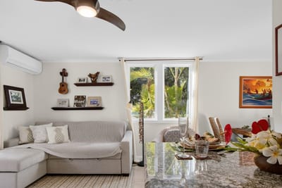 Comfortable living room with tropical decor and relaxing garden views