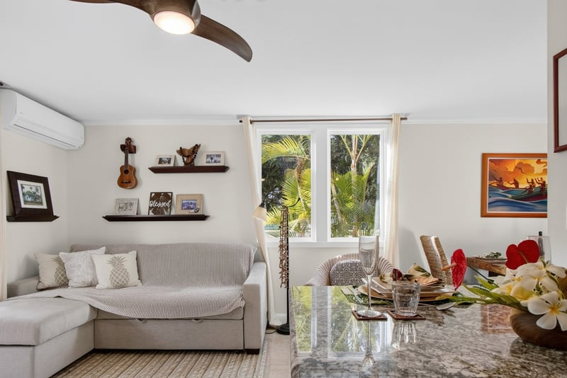 Comfortable living room with tropical decor and relaxing garden views