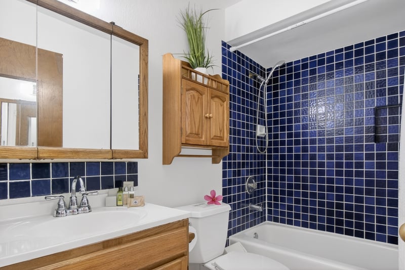 Step into a cozy retreat where rich navy tiles and warm wood finishes meet in a perfect splash of retro hospitality KUL-E113