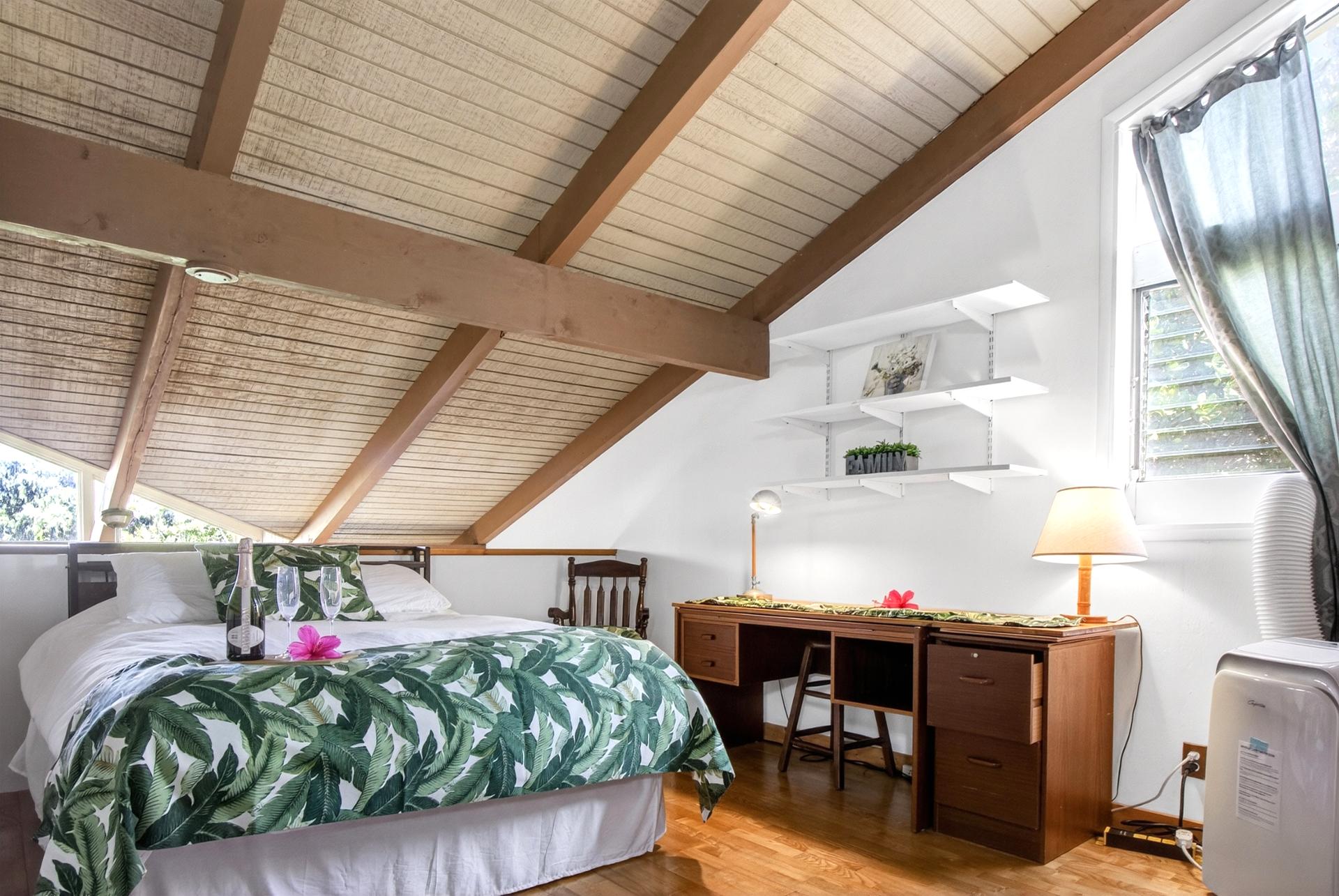 The welcoming guest room features bright natural light and island touches