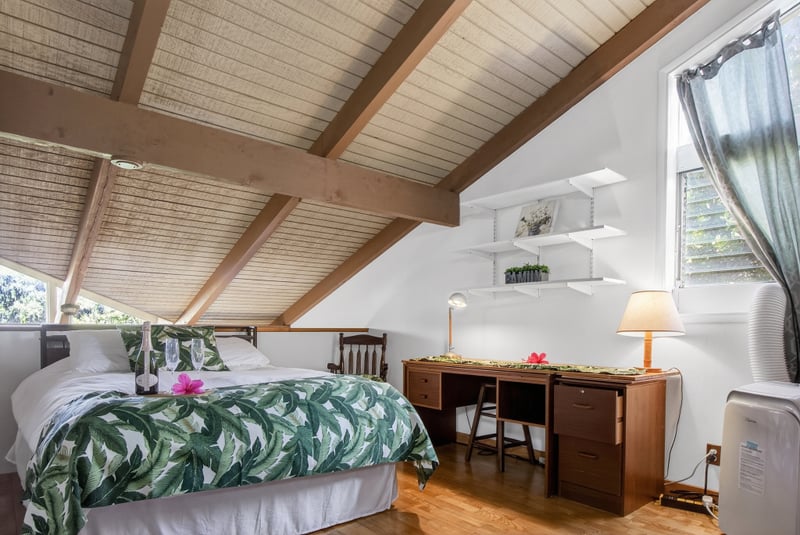 The welcoming guest room features bright natural light and island touches KUL-E113