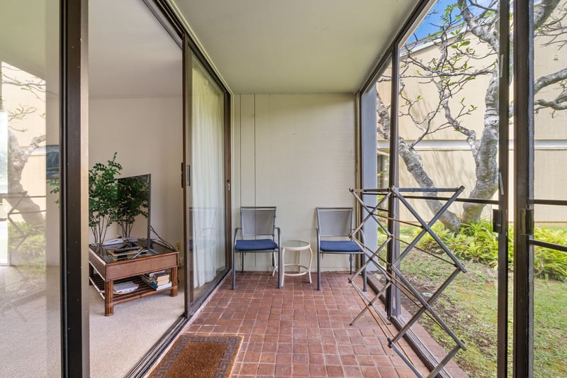 This screened lanai offers the perfect perch to sip, sway, and spy on butterflies flitting through the garden
