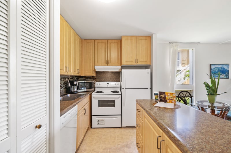 Tucked beneath soft light and breezy white shutters, this kitchen is equal parts island soul and home-cooked simplicity