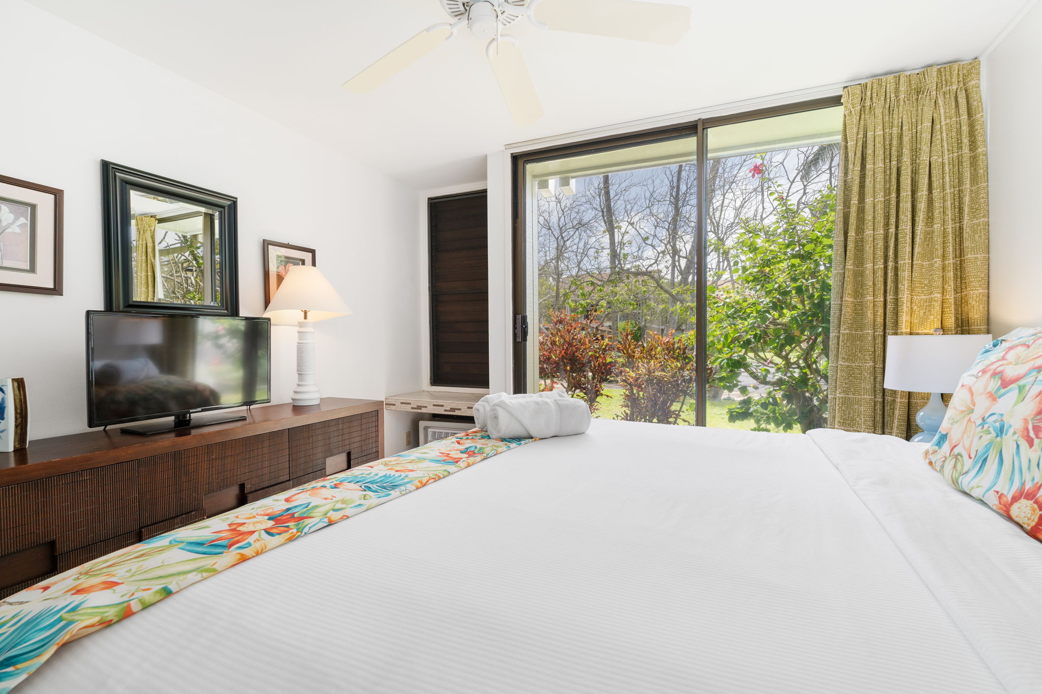 From floral bedding to sunlight dancing through the trees, this room radiates aloha in every cozy detail    