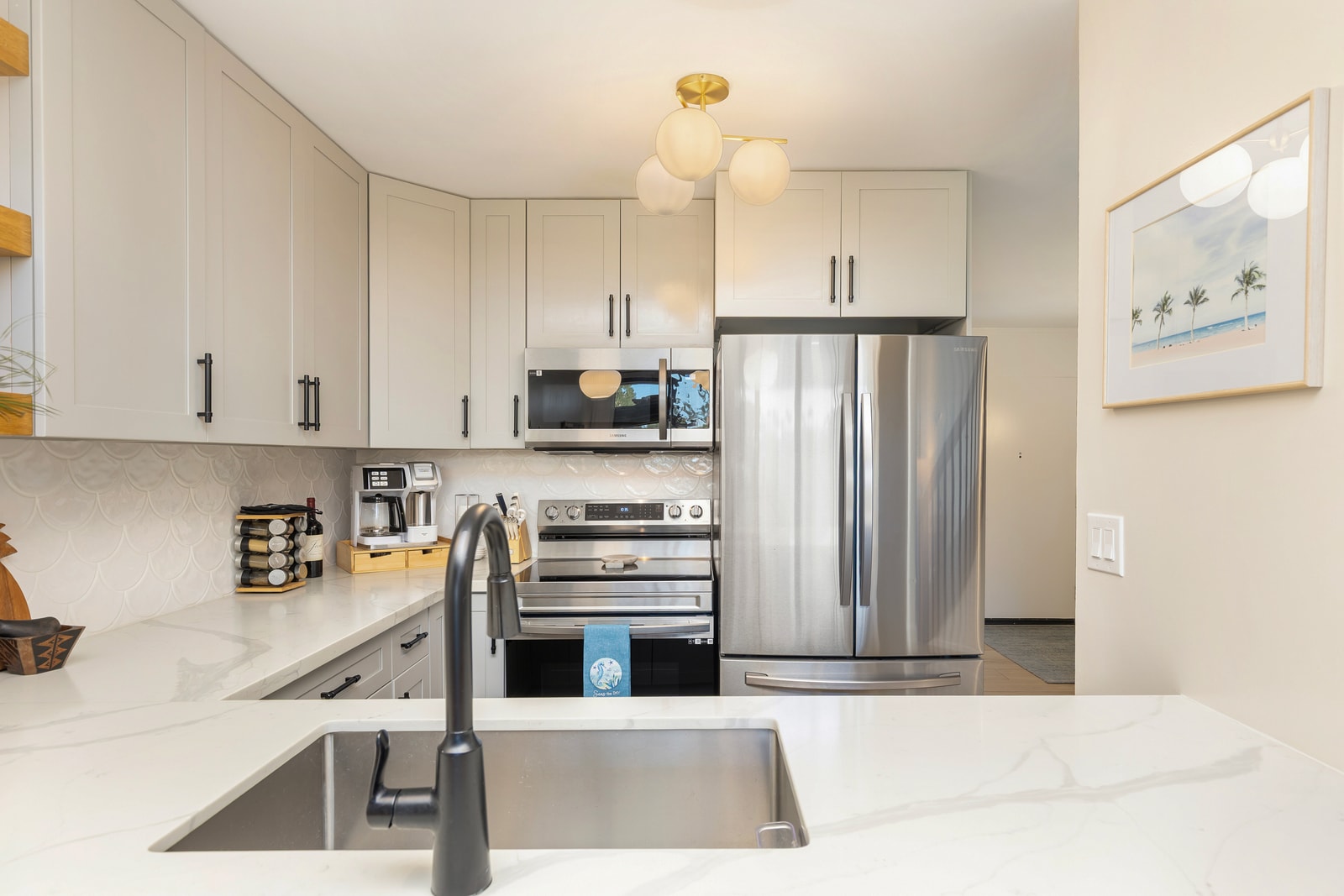 The fully equipped kitchen has everything you need to cook your favorite meals, with quartz countertops and modern stainless steel appliances. 