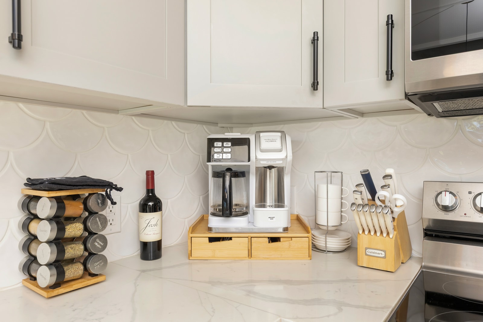 Guests enjoy the additional conveniences of a spice rack and coffee maker to make cooking in this kitchen a breeze. 