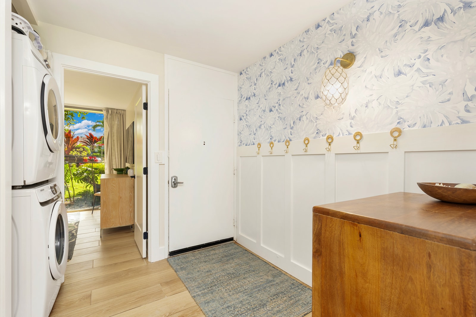 The entrance to your condo on the main floor provides easy access to the first guest bedroom, washer and dryer, as well as the main living space and kitchen. 