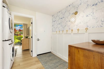 The entrance to your condo on the main floor provides easy access to the first guest bedroom, washer and dryer, as well as the main living space and kitchen. KUL-W11