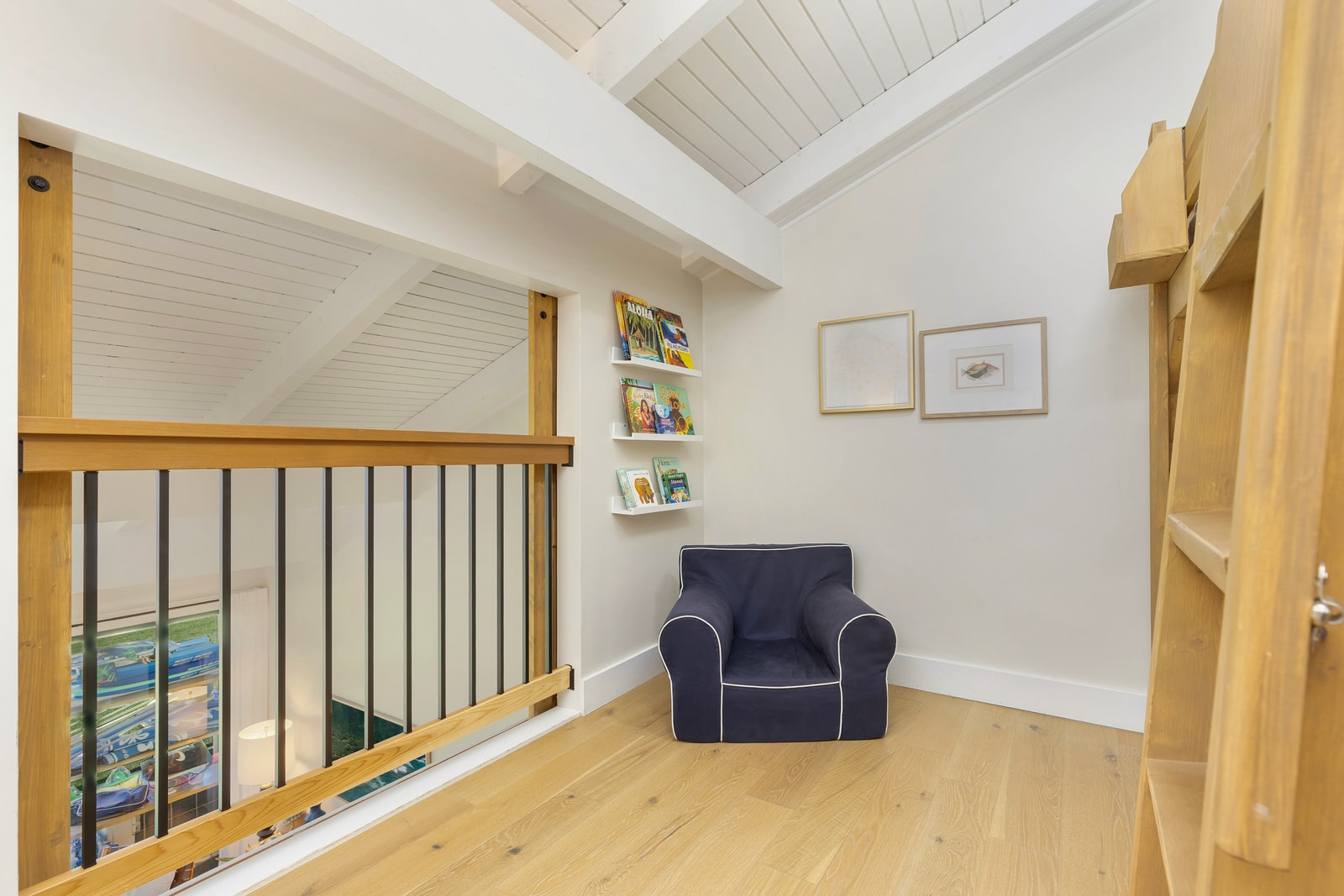 Tucked away in the corner of the upstairs loft, this cozy nook includes the perfect reading spot for quiet space to relax.