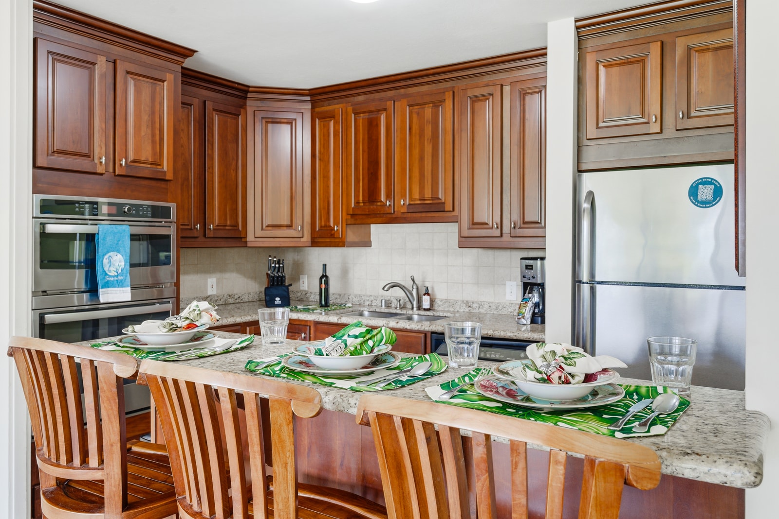 Granite counters, full-size stainless appliances, and rich wood cabinetry offer both form and function.