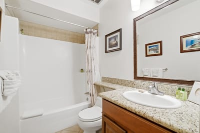 Your guest bath features granite counters and a tub-shower combo for easy rinsing after the beach.