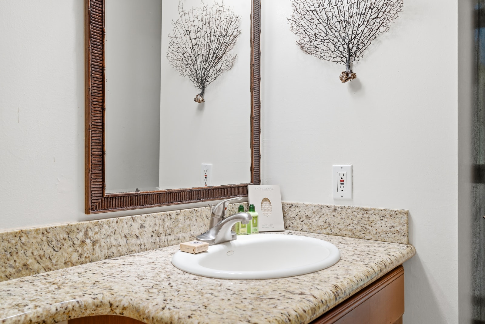 Simple and functional, with granite vanity and soft lighting.