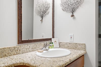 Simple and functional, with granite vanity and soft lighting.