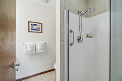 Walk-in shower in your ensuite bathroom offers easy access and a clean finish.