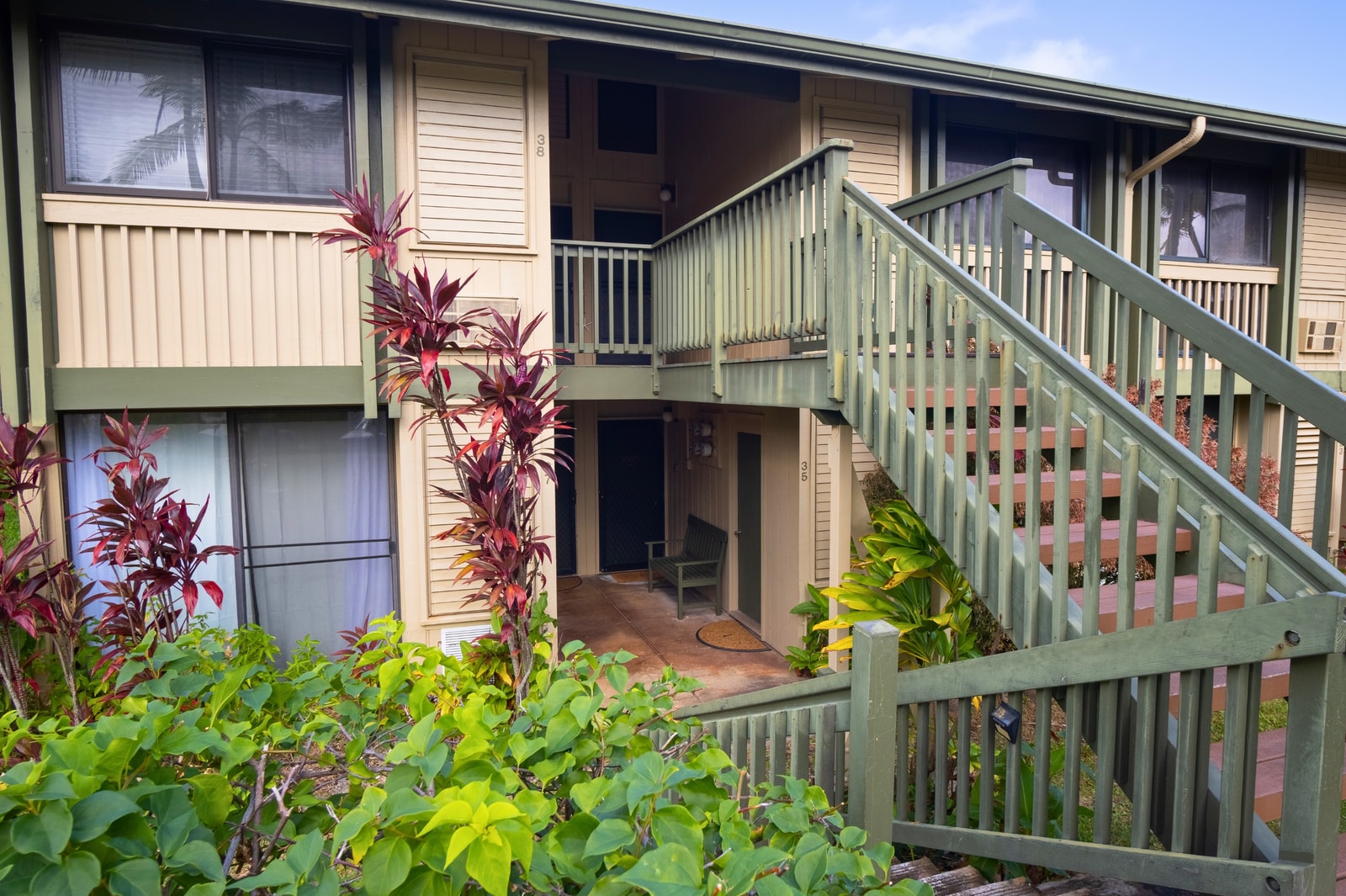 Your villa is surrounded by lush, tropical plants like palm trees and Ti plants.