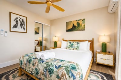 Soft lighting, tropical tones, and a Queen bed make this ground-floor bedroom the perfect retreat after exploring Oahu.