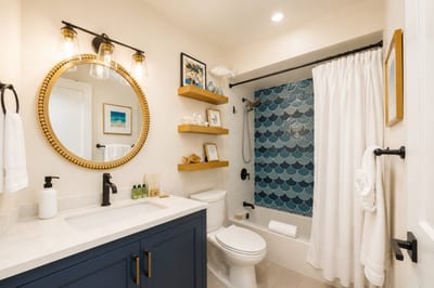 The shared bathroom on the main level includes a quartz vanity and full tub-shower combo, perfect for refreshing after beach time.